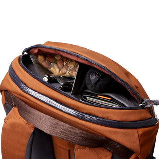 Bellroy Venture Ready Pack 20L in brown showing organized interior with snacks and travel essentials