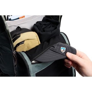 Bellroy Venture Ready Pack 20L showing open compartment with folded clothes and black cap being stored inside