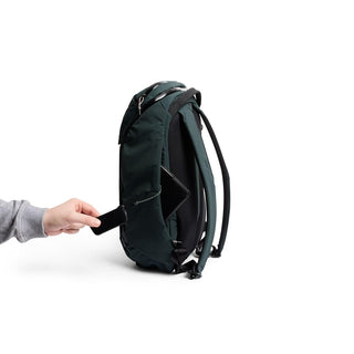 Bellroy Venture Ready Pack 20L showing side access pocket with person placing a phone inside