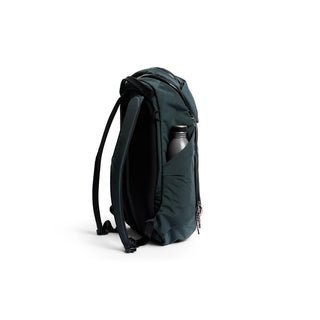 Bellroy Venture Ready Pack 20L in dark green with side pocket holding a water bottle and padded straps