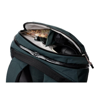 Bellroy Venture Ready Pack 20L in deep green showing organized top compartment with multiple items inside