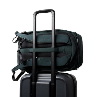 Bellroy Venture Ready Pack 20L attached to suitcase handle with padded recycled fabric straps