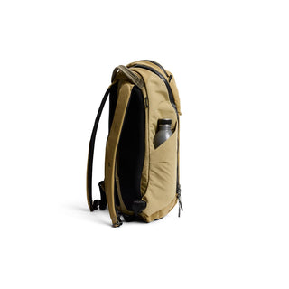 Bellroy Venture Ready Pack 20L in tan with side pocket holding a silver water bottle viewed from side angle