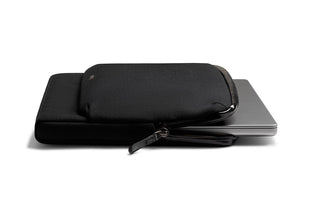 Bellroy Laptop Caddy 14" in black fabric partially holding a slim laptop with zipper detail