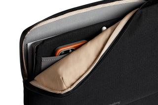 Bellroy Laptop Caddy 14 with black exterior and beige soft interior holding phone and notebook