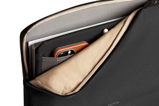 Bellroy Laptop Caddy 16 with black recycled fabric and beige interior holding laptop and phone pockets