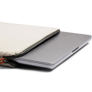 Bellroy Lite Laptop Sleeve 14" in light fabric with black trim protecting a silver laptop partially inside