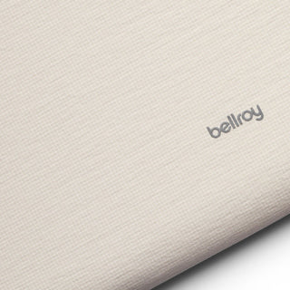 Bellroy Lite Laptop Sleeve 14 in light beige fabric with subtle texture and logo detail