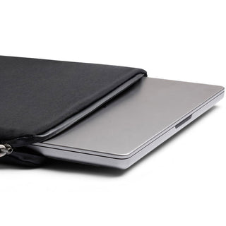 Bellroy Lite Laptop Sleeve 14" in black with smooth recycled fabric partially holding a silver laptop