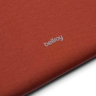 Bellroy Lite Laptop Sleeve 14" in burnt orange fabric with subtle texture and silver logo detail