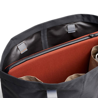 Bellroy Lite Laptop Sleeve 14" in black fabric with orange padded interior and zipper detail