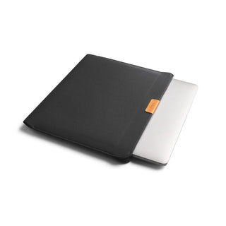 Bellroy Laptop Sleeve 16" in black recycled fabric with leather tag, partially open with laptop inside