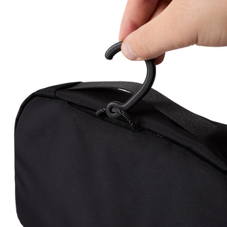 Bellroy Hanging Toiletry Kit showing durable fabric with a hook held by hand on white background