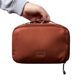 Bellroy Hanging Toiletry Kit in rust color with smooth recycled nylon fabric and sturdy top handle