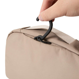 Bellroy Hanging Toiletry Kit in beige showing black hook for convenient hanging and travel use