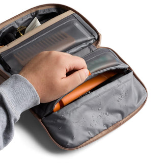 Bellroy Hanging Toiletry Kit opened showing water-resistant compartments and organized personal items inside
