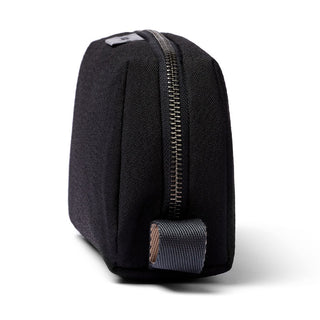 Bellroy Toiletry Kit in black recycled fabric showing side profile with zipper and fabric pull tab