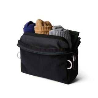 Bellroy Lite Packing Pouch 2L in black with open zipper and folded clothing inside