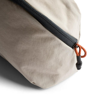 Bellroy Lite Packing Pouch 3L in beige recycled nylon with black zipper and orange pull tab detail