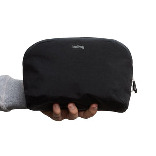 Black Bellroy Lite Packing Pouch 3L made from recycled nylon held in hand against white background