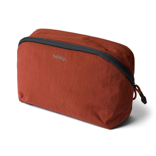 Bellroy Lite Packing Pouch 3L in rust red with recycled nylon fabric and black zipper detail