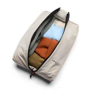Bellroy Lite Packing Caddy 8L beige fabric organizer with folded colorful clothes inside