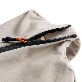 Bellroy Lite Packing Caddy 8L beige fabric with black zipper and orange cord zipper pull close-up