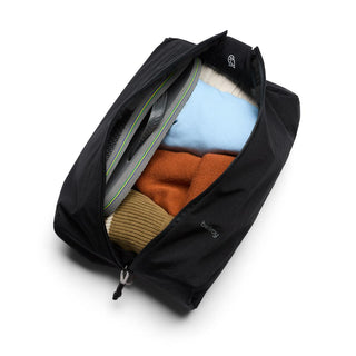 Bellroy Lite Packing Caddy 8L in black fabric with folded clothes packed inside and zipper open