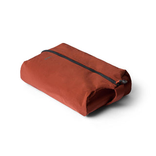 Bellroy Lite Packing Caddy 8L in rust fabric with black zipper, shown closed on white background