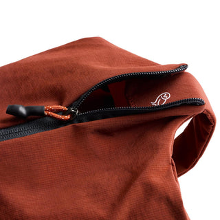 Bellroy Lite Packing Caddy 8L in rust red with durable textured recycled nylon fabric and black zipper detail