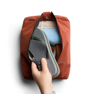 Bellroy Lite Packing Caddy 8L in rust with durable recycled fabric holding clothes and sandals