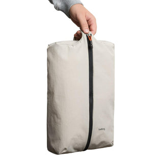 Bellroy Lite Packing Caddy 10L in light beige with vertical zipper and soft recycled fabric texture
