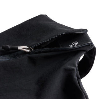 Bellroy Lite Packing Caddy 10L in black recycled nylon with partially open zipper showing interior lining