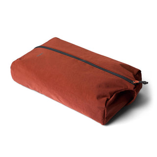 Bellroy Lite Packing Caddy 10L in burnt orange with a smooth fabric surface and black zipper closure