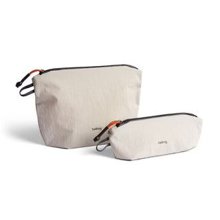 Bellroy Lite Pouch Duo in light beige recycled nylon with black zippers and orange pull tabs