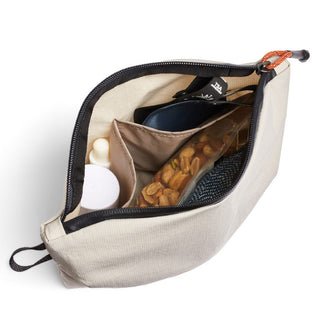Bellroy Lite Pouch Duo in light beige showing organized compartments with snacks and personal items inside