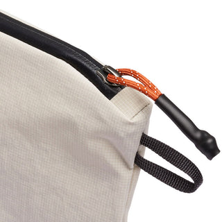 Bellroy Lite Pouch Duo close-up of beige recycled fabric with orange zipper pull and black strap loop