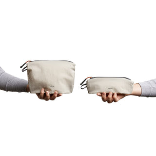 Bellroy Lite Pouch Duo held in hands showing recycled fabric texture and compact zippered design