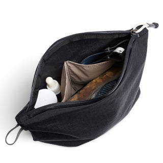 Bellroy Lite Pouch Duo showing organized interior compartments with personal care items inside black fabric pouch