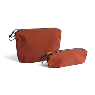 Bellroy Lite Pouch Duo in burnt orange recycled nylon with dual zipper closures and minimalist design