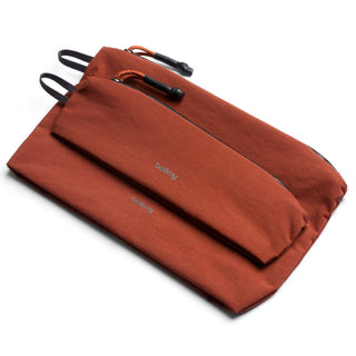Bellroy Lite Pouch Duo in rust fabric with front zipper compartments and textured recycled nylon material