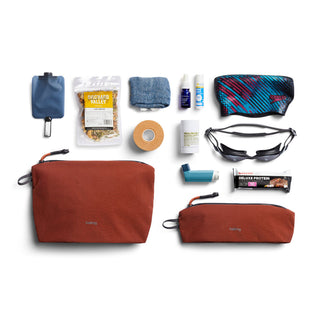 Bellroy Lite Pouch Duo set in rust color with two nylon pouches and neatly arranged travel essentials