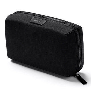 Black fabric Bellroy Tech Kit with textured surface and zippered closure displayed at angle