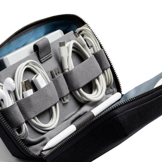Bellroy Tech Kit in black with organized tech cables and accessories secured by elastic straps