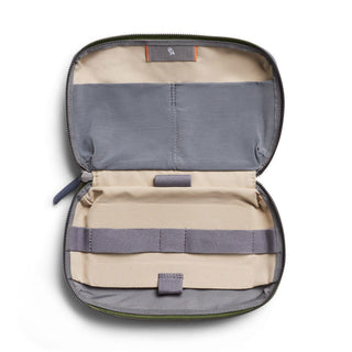 Bellroy Tech Kit open flat showing beige and gray recycled fabric compartments and elastic straps inside compact case