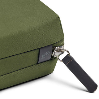 Close-up of olive green Bellroy Tech Kit corner with textured fabric and silver zipper pull tab