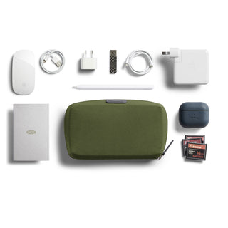 Bellroy Tech Kit with olive green recycled fabric pouch and organized tech accessories neatly arranged