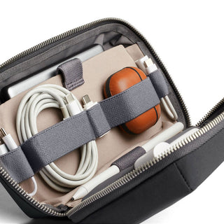 Bellroy Tech Kit in charcoal gray holding cables and small tech accessories in elastic straps