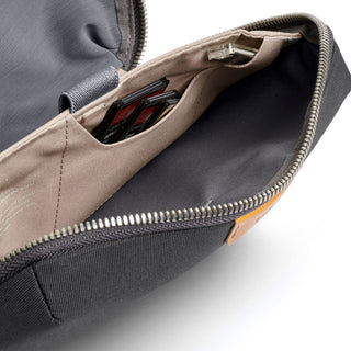 Bellroy Tech Kit open showing organized interior pockets with recycled fabric lining and zip closure