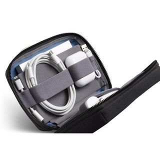 Bellroy Tech Kit Compact in black with organized cables and white charging accessories inside